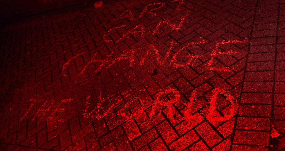 Written in chalk on the pavement, it reads 'Art Can Change The World' the photo has a red wash.