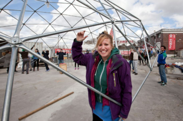 Kirstin Shirling holds up a section of a geodome which is being put together