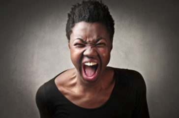 A woman roaring with her mouth open