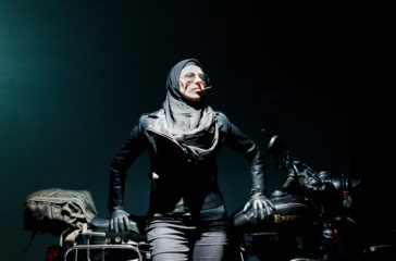 Artist Cigdem Aydemir seated on a motorbike