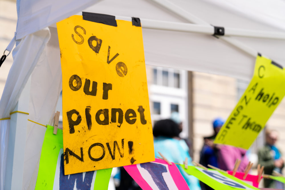 Poster reads 'Save Our Planet Now!'