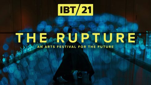 A photo of a figure kneeling in a dark space lit by blue lights. Yellow text over the image reads 'IBT21, The Rupture, An arts festival for the future